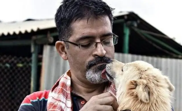 A man abandons his career and provides shelter for stray dogs