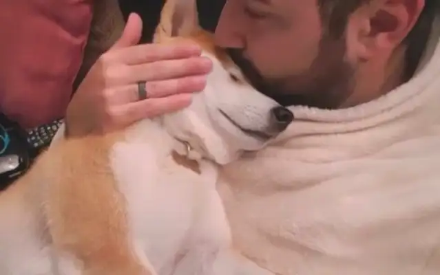 Since he was a kid, the dog sleeps in the master's hand