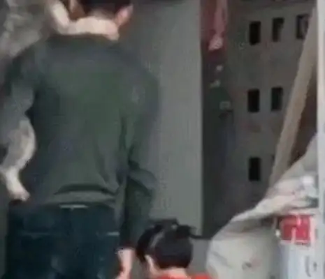 A man with a pet dog on his shoulder with his daughter in his hand. Warm. Heart